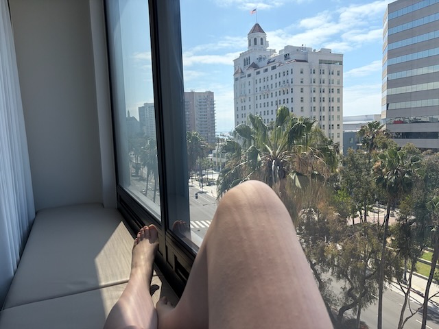 Me basking in the bay window of the hotel in Long Beach
